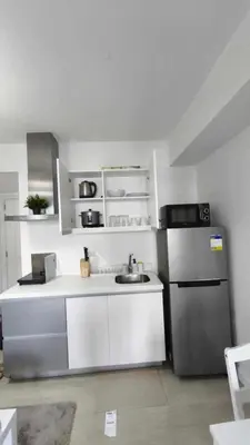 a kitchen with a sink and a refrigerator at Casa Elisha Azure Urban Resort Staycation in Manila