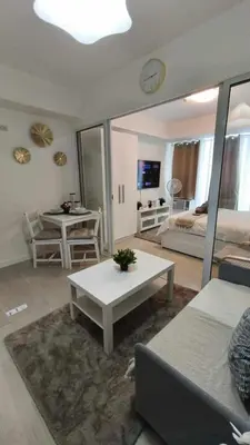 a living room with a couch and a table at Casa Elisha Azure Urban Resort Staycation in Manila