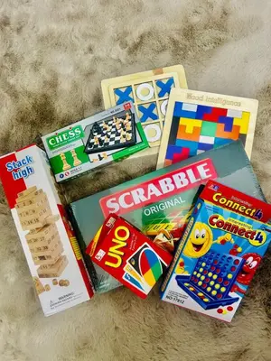 a pile of childrens games and books on a carpet at Casa Elisha Azure Urban Resort Staycation in Manila