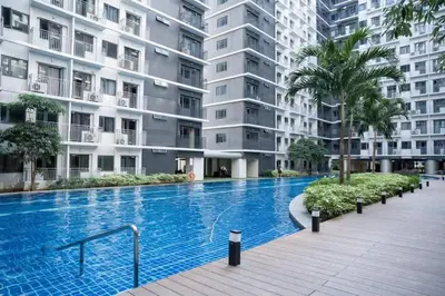 a large swimming pool in front of a building at Aldo mall of Asia shore 3 residence in Manila