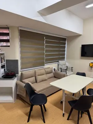 a living room with a couch and a table at Greenhills commercial center 1-2BR condominium in Manila