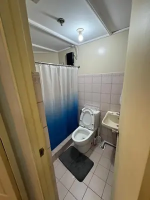 a bathroom with a toilet and a sink at Greenhills commercial center 1-2BR condominium in Manila