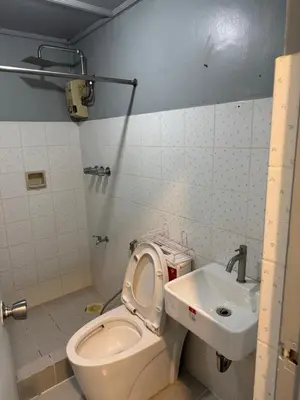 a bathroom with a toilet and a sink at Greenhills commercial center 1-2BR condominium in Manila