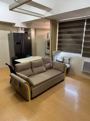 a living room with a couch and a table at Greenhills commercial center 1-2BR condominium in Manila