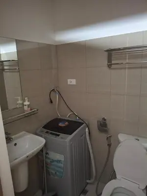 a small bathroom with a toilet and a sink at Simplicity in Manila