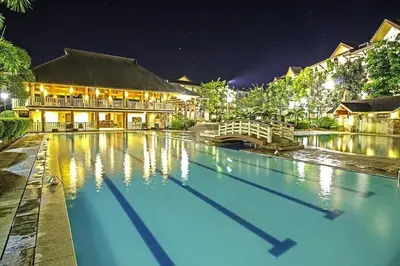 a swimming pool in front of a building at night at Staycation with Mickey & Minnie One Oasis Pasig in Manila