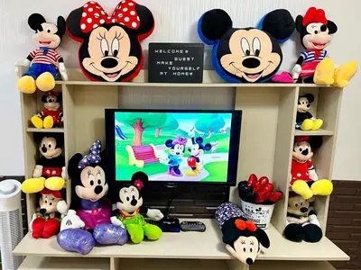 a room with a tv and a bunch of stuffed animals at Staycation with Mickey & Minnie One Oasis Pasig in Manila