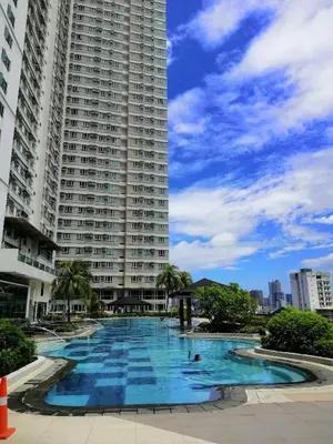 a large apartment building with a large swimming pool at Studio Unit at The Beacon Makati in Manila