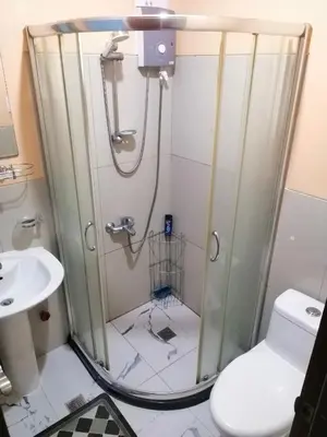 a shower in a bathroom with a toilet and a sink at Studio Unit at The Beacon Makati in Manila