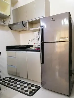 a stainless steel refrigerator in a kitchen with a checkered floor at Studio Unit at The Beacon Makati in Manila