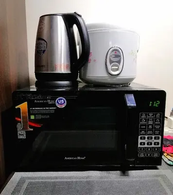 a microwave with a coffee pot on top of it at Studio Unit at The Beacon Makati in Manila