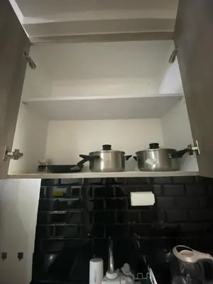 two pots and pans on a stove in a kitchen at The Skycabin at S Residences in Manila