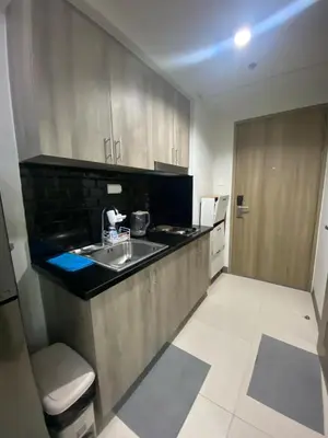 a small kitchen with a sink and a refrigerator at The Skycabin at S Residences in Manila