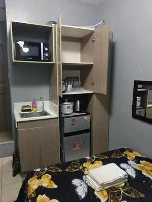 a small kitchen with a sink and a counter top at Berto's High Speed Wifi in Manila