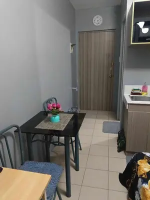 a kitchen and dining room with a table and a table and chairs at Berto's High Speed Wifi in Manila