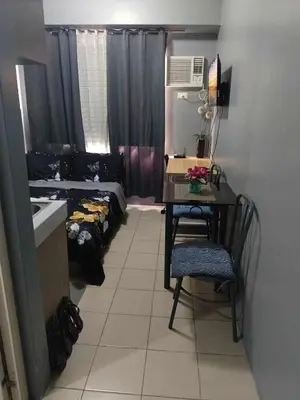 a room with a desk and a room with a bed at Berto's High Speed Wifi in Manila