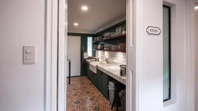 a kitchen with green cabinets and a sink at MIRANAMIN NEST Elegant Home, Indoor Plunge Pool, Pet-Friendly, with Rooftop, Kitchens, Self-Service Breakfast - Ideal for Reunions, Team Building, Intimate Gatherings in Manila
