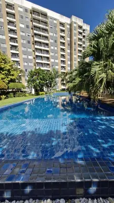 a large swimming pool in front of a building at NEW! The Hive Residences - 1BR with Balcony & FREE Parking at Casa Arbo in Taytay