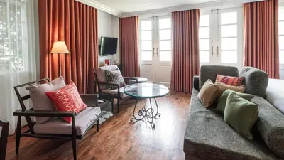 a living room with a couch and chairs and a table at MiraNamin Nest BANABA - Garden View Suite in Historic Home - Bathtub, Luxury Indoor Plunge Pool, Guest Kitchen, Self-Service Breakfast, Rooftop, Pet-Friendly in Manila