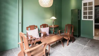 a dining room with chairs and a wooden table at MiraNamin Nest BANABA - Garden View Suite in Historic Home - Bathtub, Luxury Indoor Plunge Pool, Guest Kitchen, Self-Service Breakfast, Rooftop, Pet-Friendly in Manila