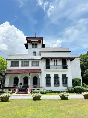 a large white building with a tower on top of it at MiraNamin Nest CALACHUCHI - Cozy Room in Historic Home - Indoor Plunge Pool, Petite Desk, Garden View with Balcony, Self-Service Breakfast, Guest Kitchen, Rooftop, Pet-Friendly in Manila