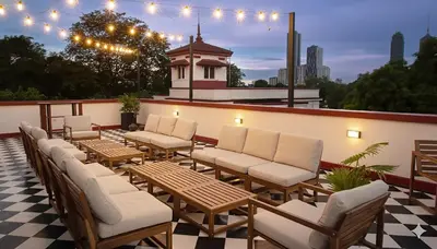 a row of chairs and tables on a patio at MiraNamin Nest KAMANTIGI - Two Bed Suite in Historic Home with Luxury Indoor Plunge Pool, Garden Access, Self-Service Breakfast, Guest Kitchen, Pet-Friendly in Manila