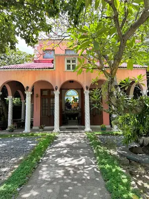 an orange building with a walkway in front of it at MiraNamin Nest LANTANA - Luxury Suite in Unique Historic Home with Garden Access, Indoor Plunge Pool, Self-Service Breakfast, Rooftop, Bathtub, Private Kitchen in Manila