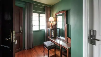 a room with a desk and a mirror and a window at MiraNamin Nest LANTANA - Luxury Suite in Unique Historic Home with Garden Access, Indoor Plunge Pool, Self-Service Breakfast, Rooftop, Bathtub, Private Kitchen in Manila