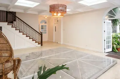 an empty living room with a glass floor at MiraNamin Nest LANTANA - Luxury Suite in Unique Historic Home with Garden Access, Indoor Plunge Pool, Self-Service Breakfast, Rooftop, Bathtub, Private Kitchen in Manila