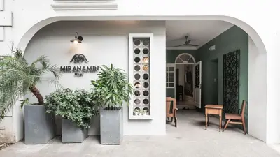 an entrance to a house with potted plants at MiraNamin Nest LANTANA - Luxury Suite in Unique Historic Home with Garden Access, Indoor Plunge Pool, Self-Service Breakfast, Rooftop, Bathtub, Private Kitchen in Manila