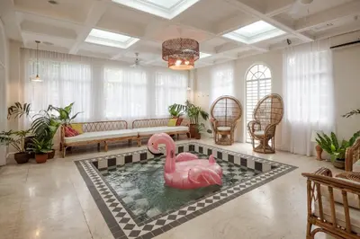 a pool with a pink swan in the middle of a living room at MiraNamin Nest LIRYO and LANTANA - Luxury Residence in Unique Historic Home - Indoor Plunge Pool, Self-Service Breakfast, Garden View, Rooftop, Private Kitchen in Manila