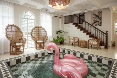 a swimming pool with a pink swan in a house at MiraNamin Nest LIRYO and LANTANA - Luxury Residence in Unique Historic Home - Indoor Plunge Pool, Self-Service Breakfast, Garden View, Rooftop, Private Kitchen in Manila