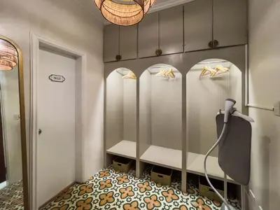 a dressing room with four stalls with gold shoes at MiraNamin Nest LIRYO and LANTANA - Luxury Residence in Unique Historic Home - Indoor Plunge Pool, Self-Service Breakfast, Garden View, Rooftop, Private Kitchen in Manila