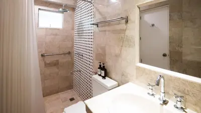 a bathroom with a toilet and a sink and a shower at MiraNamin Nest LIRYO and LANTANA - Luxury Residence in Unique Historic Home - Indoor Plunge Pool, Self-Service Breakfast, Garden View, Rooftop, Private Kitchen in Manila