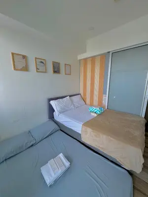 a small bedroom with two beds in it at Skyrest Staycation - Azure Urban Resort in Manila