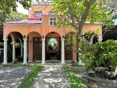 a house with a pathway leading to the front door at MiraNamin Nest ROSAL - Garden View Suite in Unique Historic Estate with Indoor Plunge Pool, Self-Service Breakfast, Guest Kitchen in Manila