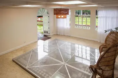 a living room with a glass floor at MiraNamin Nest ROSAL - Garden View Suite in Unique Historic Estate with Indoor Plunge Pool, Self-Service Breakfast, Guest Kitchen in Manila