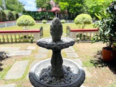 a stone fountain with a cactus in a garden at MiraNamin SAMPAGUITA - Two Bedroom Suite in Historic Home with Indoor Plunge Pool, Self-Service Breakfast, Garden View, Pet-Friendly in Manila