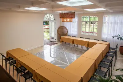 a room with rows of tables and chairs in it at MiraNamin SAMPAGUITA - Two Bedroom Suite in Historic Home with Indoor Plunge Pool, Self-Service Breakfast, Garden View, Pet-Friendly in Manila
