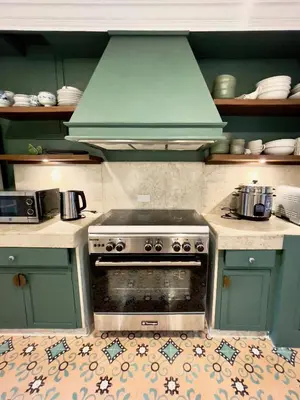 a kitchen with a stove with a green hood at MiraNamin SAMPAGUITA - Two Bedroom Suite in Historic Home with Indoor Plunge Pool, Self-Service Breakfast, Garden View, Pet-Friendly in Manila