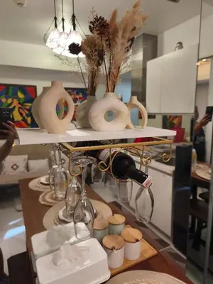 a table with vases and other items on a shelf at Paris Hilton Beach Resort in Manila