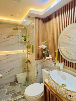a bathroom with a toilet and a sink and a mirror at Paris Hilton Beach Resort in Manila