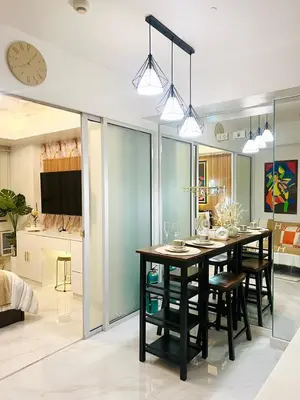 a kitchen and dining room with a table and chairs at Paris Hilton Beach Resort in Manila