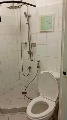 a bathroom with a shower with a toilet and a shower at SM MEZZA 1 RESIDENCES Studio Room Gian Thyresse Crib in Manila