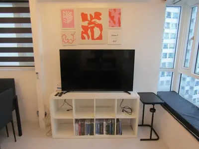 a flat screen tv sitting on top of a white entertainment center at SM MEZZA 1 RESIDENCES Studio Room Gian Thyresse Crib in Manila