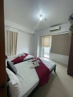 a bedroom with a bed with towels on it at 4kys staycation in Manila