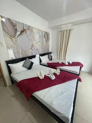 a bedroom with two beds with stuffed animals on them at 4kys staycation in Manila