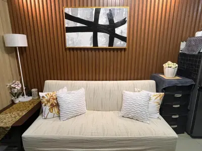a living room with a couch and a picture on the wall at Casiana Place Staycation at Shore2 Residences in Manila