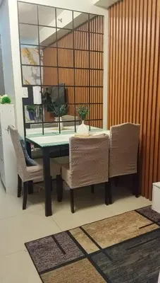 a dining room table with two chairs and a green table at Casiana Place Staycation at Shore2 Residences in Manila