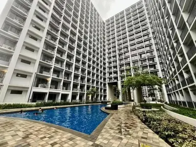 a large building with a swimming pool in front of it at Casiana Place Staycation at Shore2 Residences in Manila